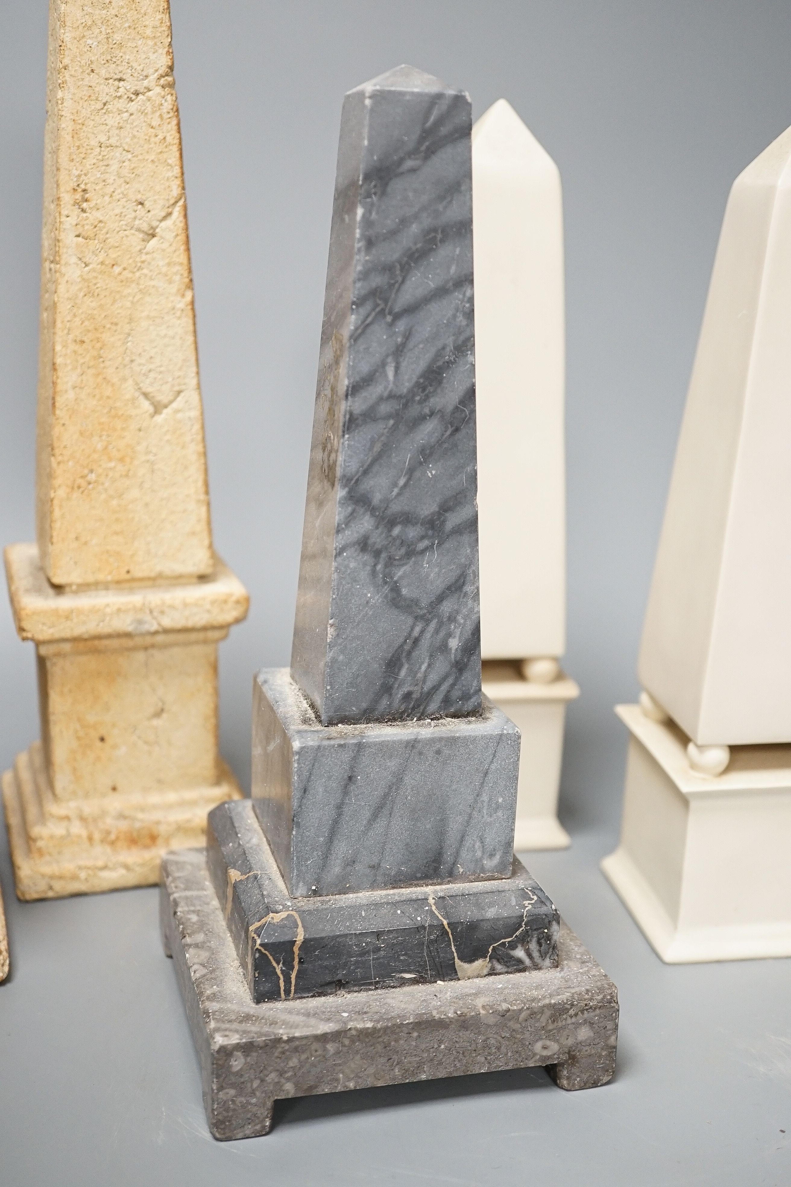 Two pairs of simulated stone obelisks, another pair and a single, tallest 33cm